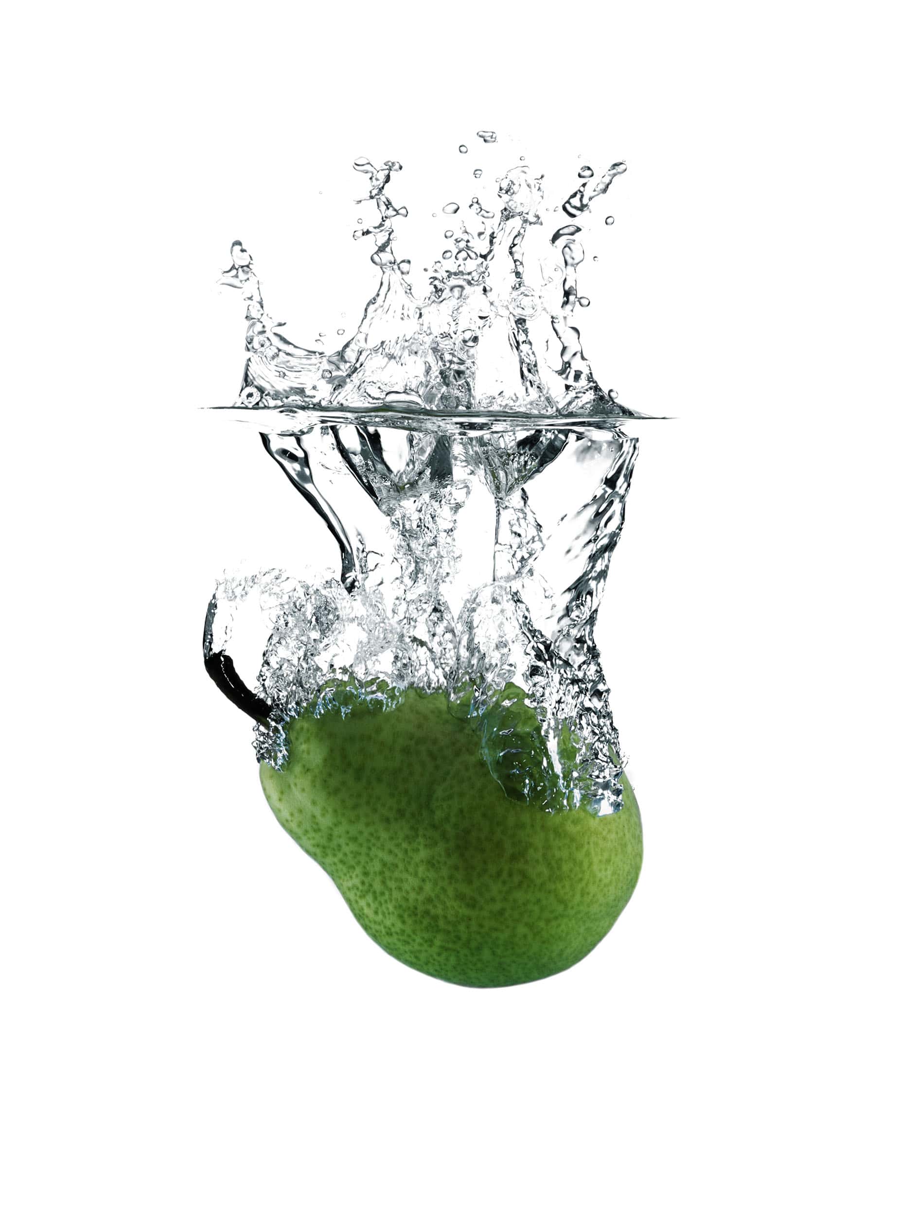 Green pear falling into water on a white background taken with high-speed photography by Jonathan Knowles