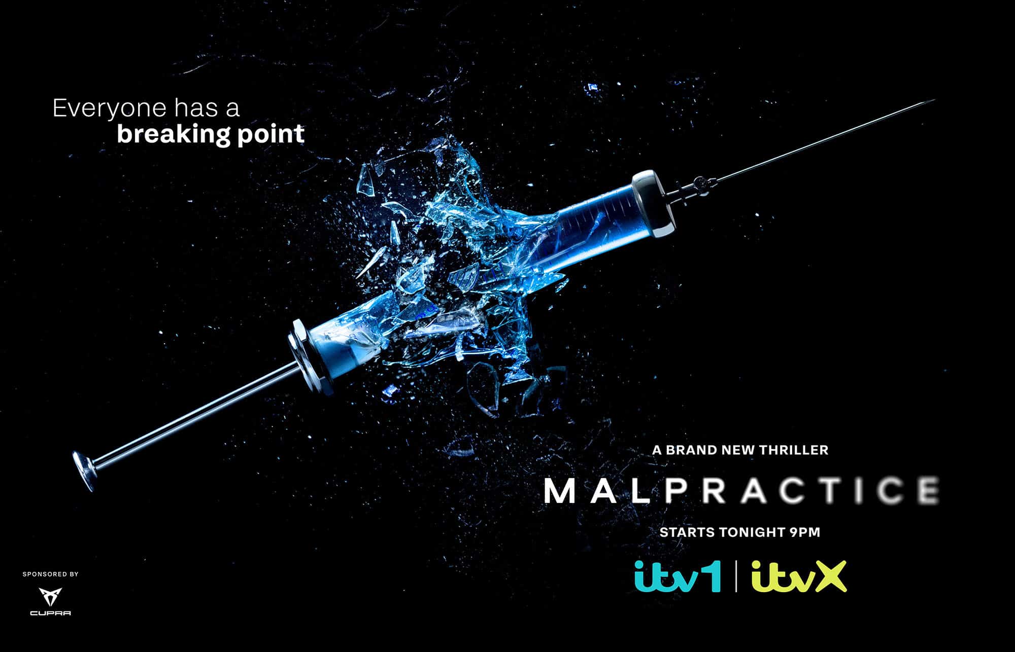 Glass syringe with blue liquid in mid explosion on a black background