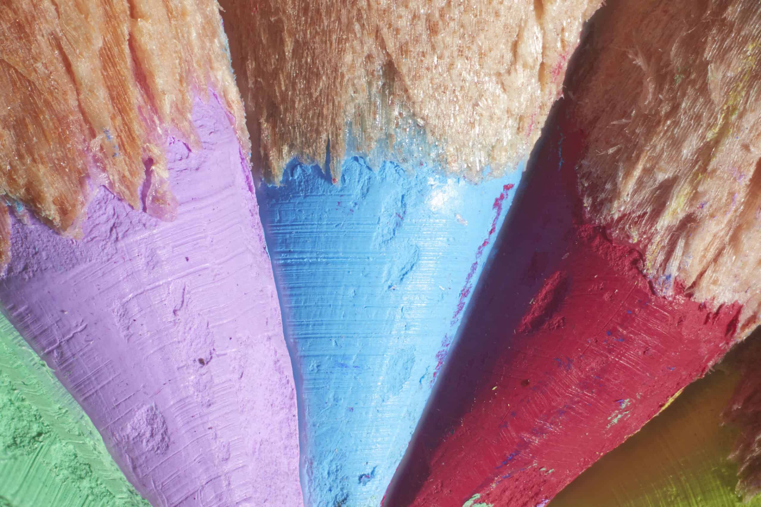Close-up image of coloured pencil tips. The colour of the pencils are green, lilac, light blue, red and yellow. The image was taken by macro photographer Jonathan Knowles
