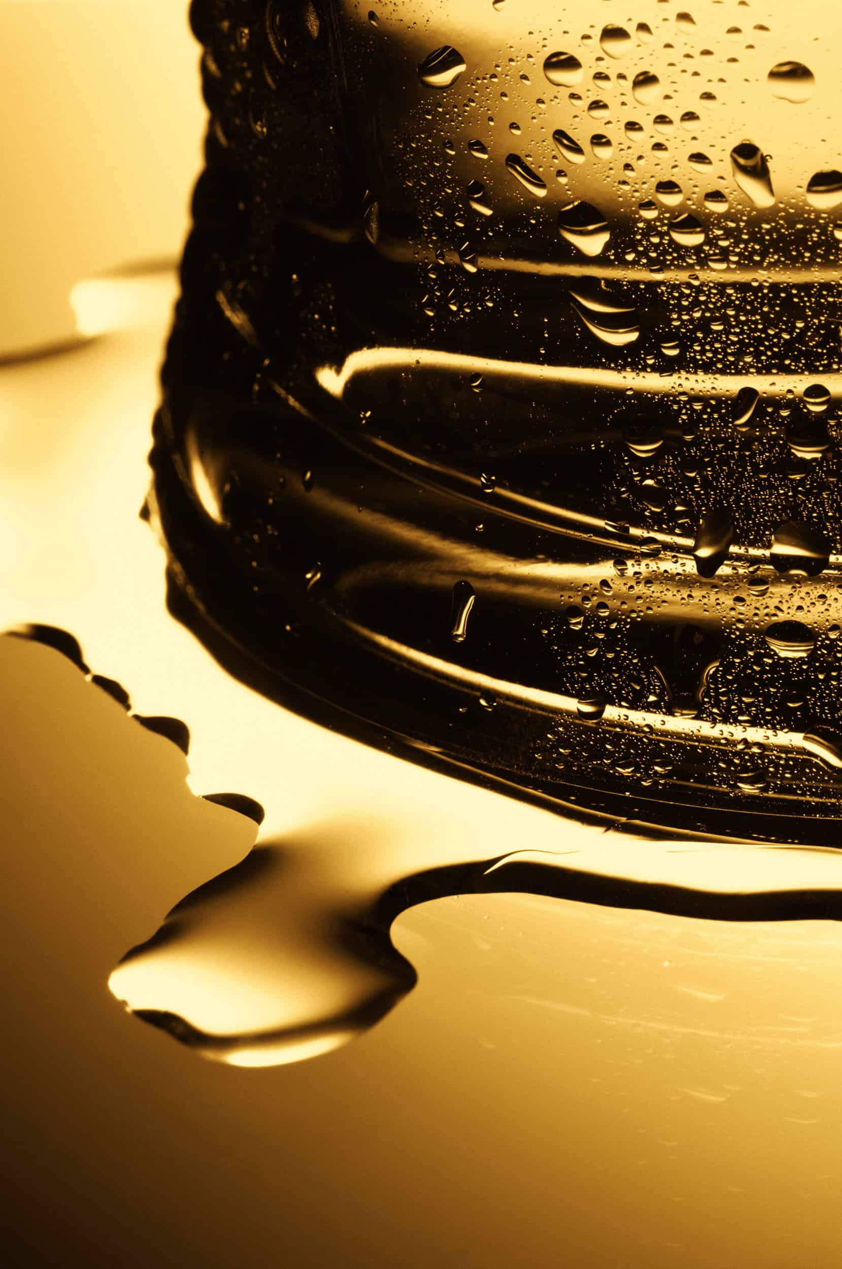 Macro photography of a chilled carling glass filled with golden beer and condensation on the outside. Shot by drinks photographer Jonathan Knowles