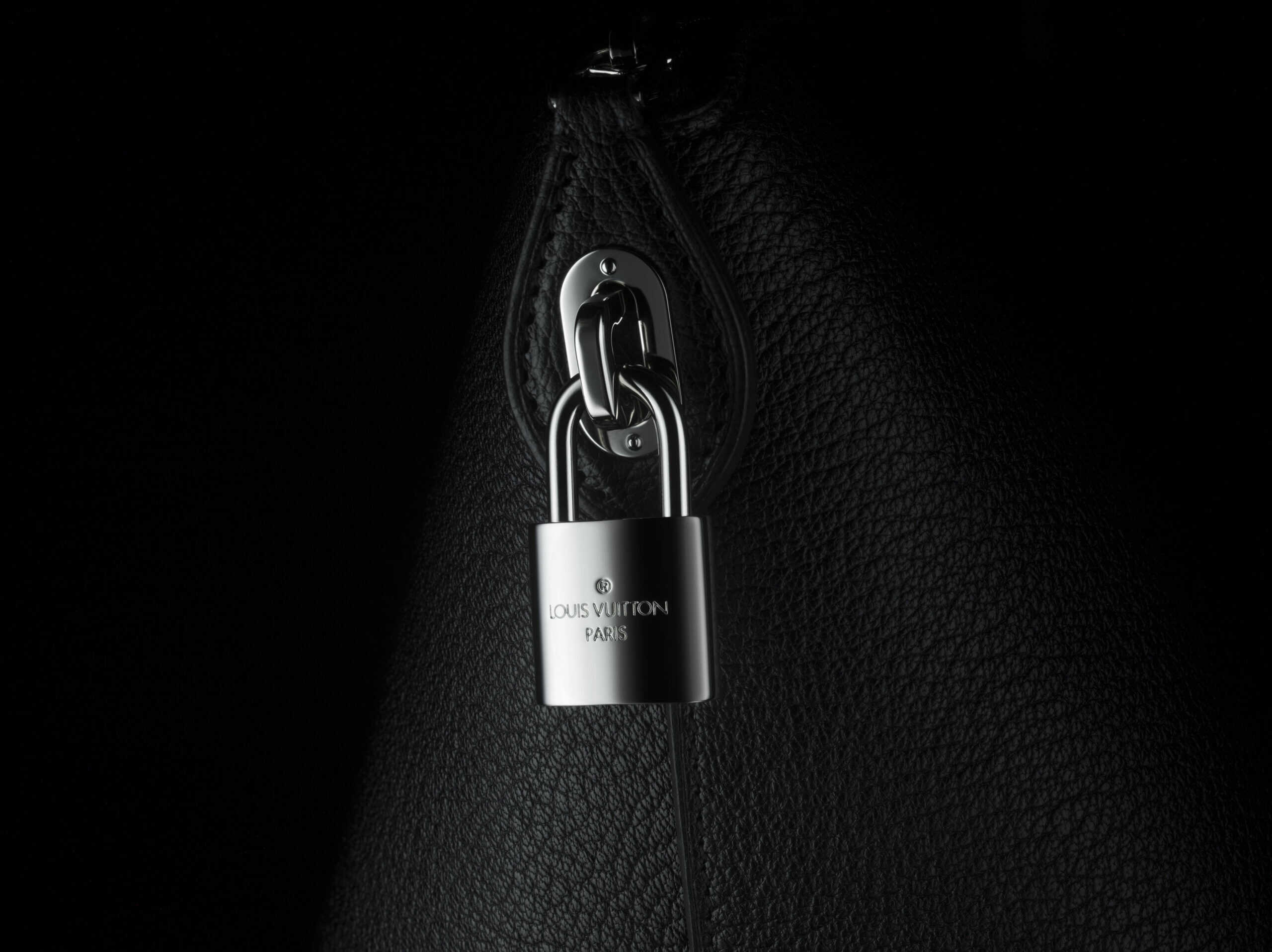Macro image of a Louis Vuitton black leather bag with a silver padlock taken by London Macro photographer Jonathan Knowles