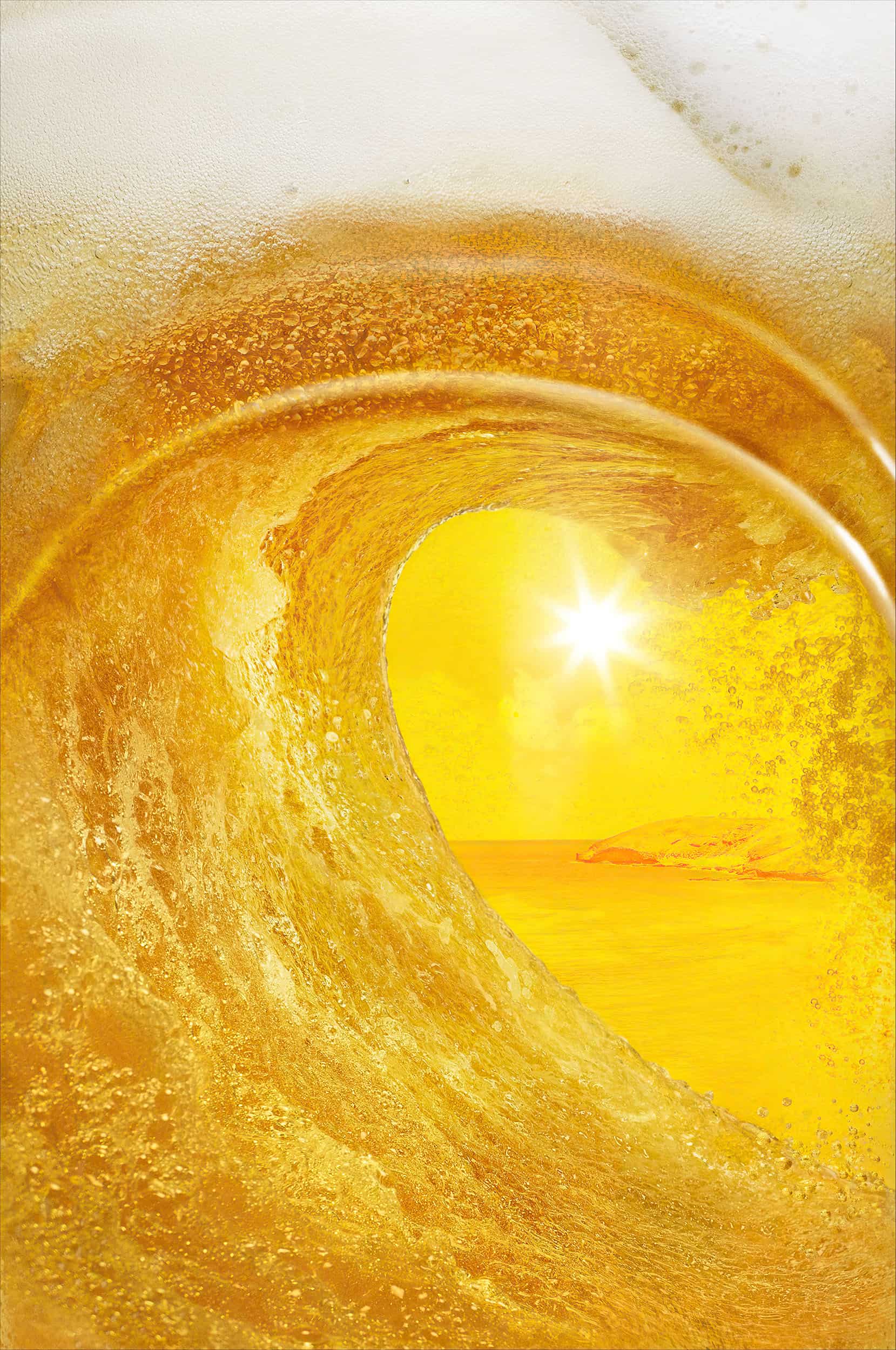Kona Big Wave - close-up of Hawaiian wave of beer inside a glass, with island scene of Kona behind. Shot by beer photographer Jonathan Knowles.