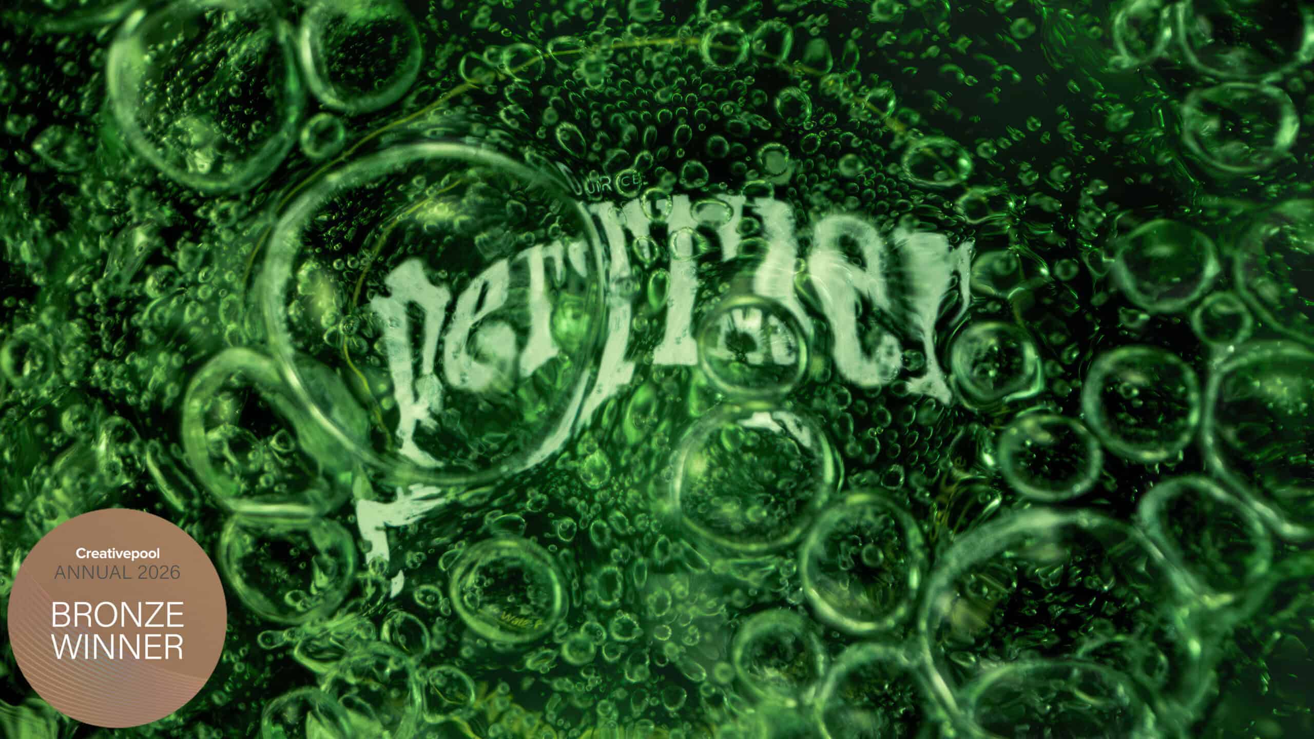 Macro image inside a green glass bottle of Perrier sparkling water. Shot by Jonathan Knowles drinks photographer.
